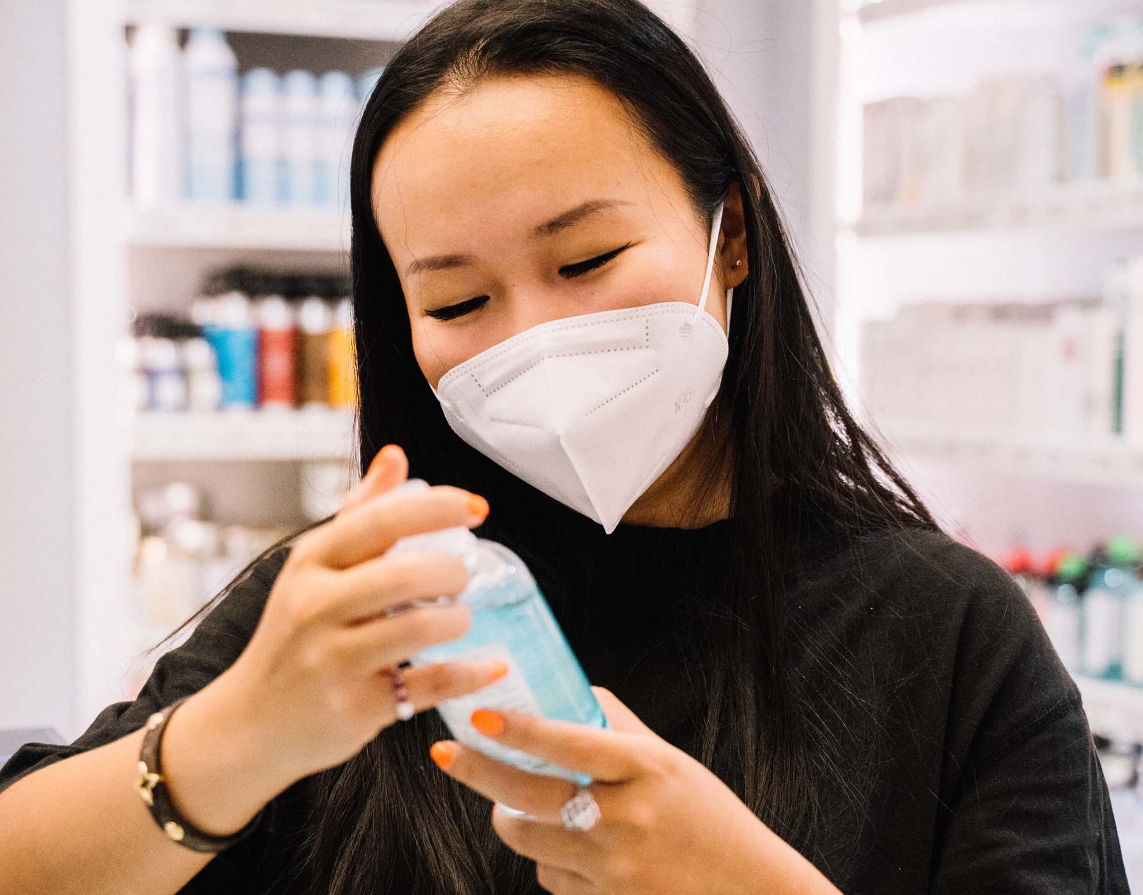 Donna in farmacia con un flacone di gel